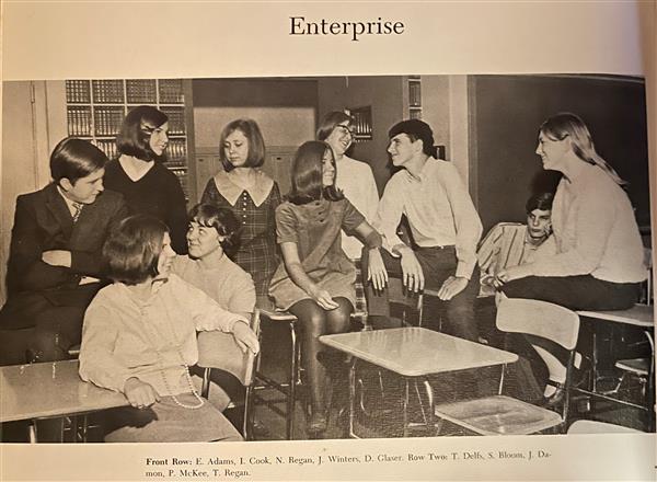 Students pose in a classroom, looking very sophisticated